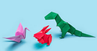 Origami of three dinosaurs on blue background