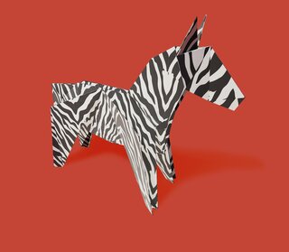 Origami zebra on red background
