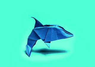 Blue origami dolphin on turquoise background
